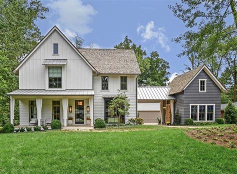 A Large House In The Middle Of A Lush Green Field