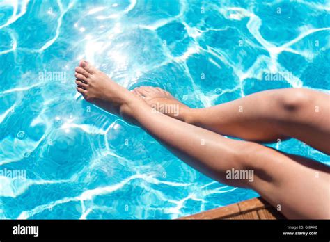 Pleasant Woman Holding Her Legs In The Swimming Pool Stock Photo Alamy