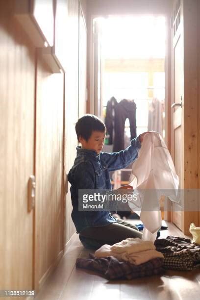 Boy Folding Laundry Photos And Premium High Res Pictures Getty Images