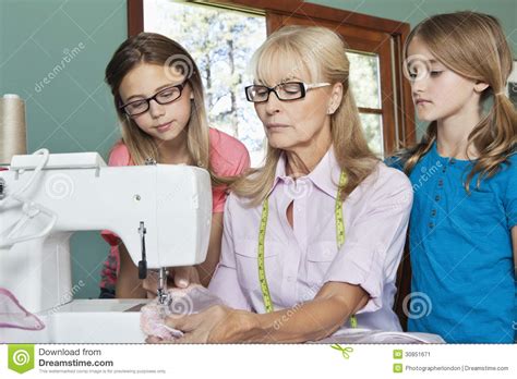 granddaughters-looking-at-grandmother-sewing-cloth-stock-image-image