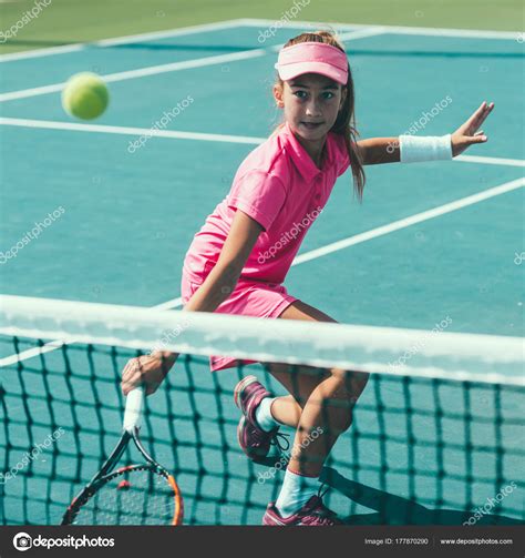 Young Girl Playing Tennis Stock Photo By ©microgen 177870290