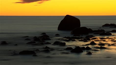 Download Wallpaper 3840x2160 Stones Water Sea Long Exposure Sunset