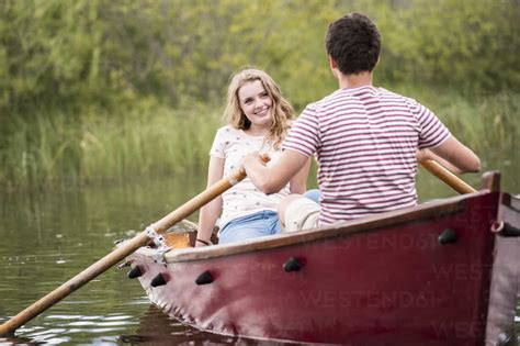 Young Couple In Rowing Boat On The Lake Stock Photo