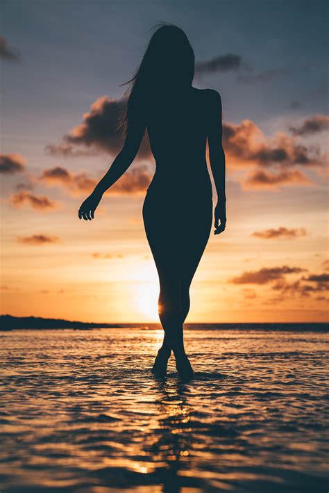 Silhouette Of Person Standing On Beach During Sunset · Free Stock Photo