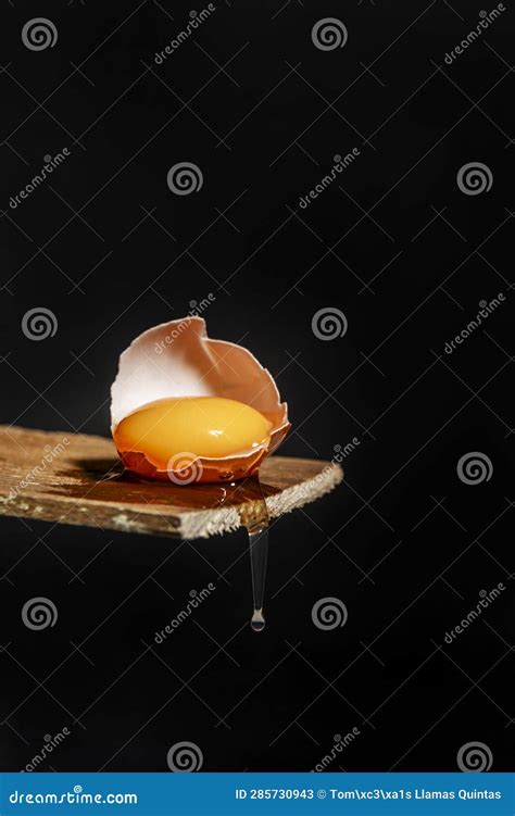 A Cracked Raw Egg With White Dripping Down Stock Image Image Of
