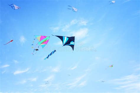Colorful Kite Flying In The Blue Sky Through The Clouds Stock Photo