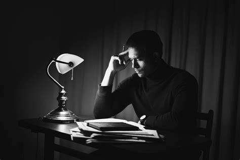 Contemplative Man Reading Book In Classy Home Office · Free Stock Photo