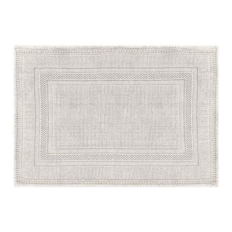 A light blue bathroom and a bright blue tile wall is refreshed with white touches and furniture. Jean Pierre Cotton Stonewash Racetrack 17 in. x 24 in ...