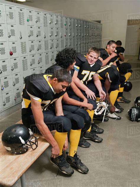 Football Players Dressing In Locker Room Stock Photo Dissolve
