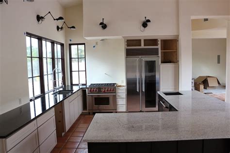 Under kitchen cabinet light helps give your kitchen a more. bianco montahna granite, black granite countertops, wolf ...