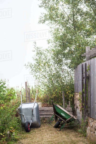Wheelbarrows In Garden Stock Photo Dissolve