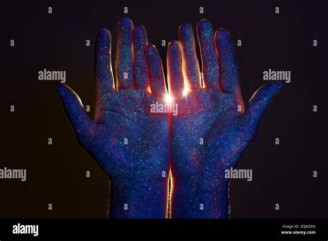 Beauty Hands In Ultraviolet Light In Drops Of Colored Paint Light