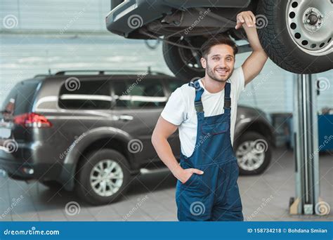Young Handsome Mechanic Working In Car Service Department Feeling Happy