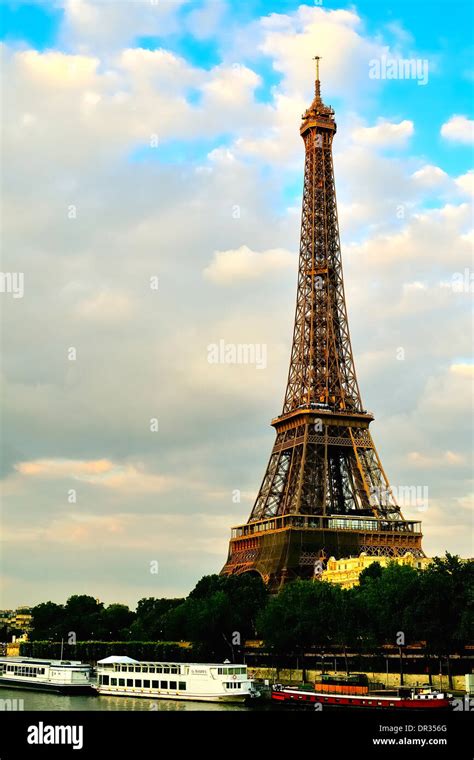 A View Of The Eiffel Tower At Dusk With The Seine River In The