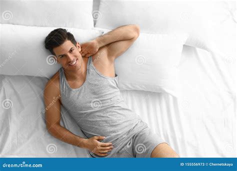 Portrait Of Handsome Man Lying On Large Bed Stock Image Image Of