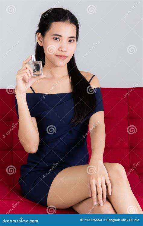 Image Of Portrait Smiling Asian Woman Sitting On Red Sofa Model Is Showing Of The