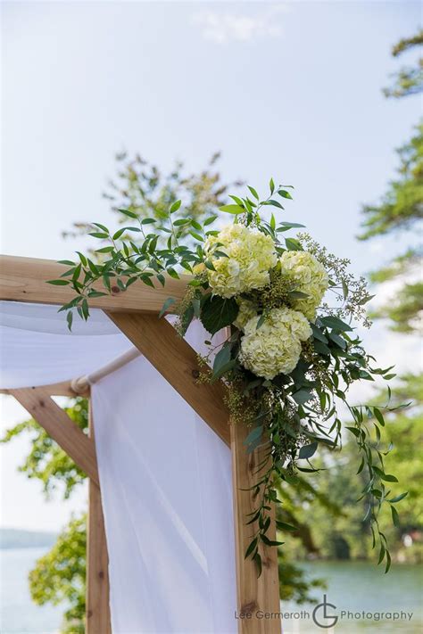 A Simple Ceremony Arbor With Accenting Corner Swags Of White Hydrangea