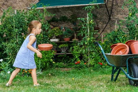 Cute Little Girl Helping Her Mother In The Backyard Stock Image Image