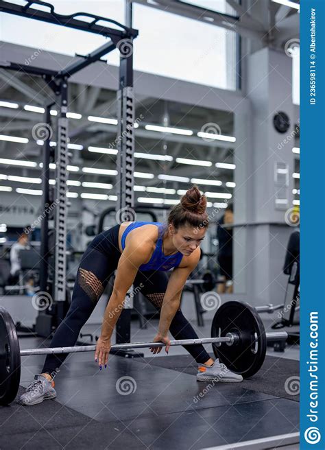 Woman Performing Doing Deadlift Exercise With Weight Bar In Fitness Gym Concentrated Stock