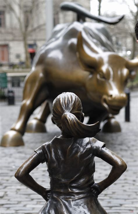 Fearless Girl Statue Stares Down Wall Streets Iconic Bull