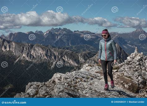 Woman Hiking Along Trail To Croda Negra Mountain Summit At Passo Di