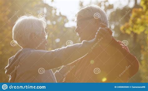 Senior Caucasian Couple Dancing In The Park Happy Retirement Concept