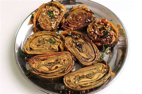 It is made from colocasia (arbi) leaves, with spicy and tangy gram flour (besan) mixture spread and stacked upon each other and rolled in a particular way to form a pinwheel and. Gujarati Patra Recipe - Patra Farsan Recipe - Easy Snack ...