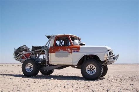An Off Road Vehicle Is Parked In The Desert