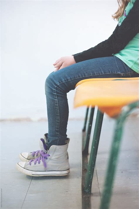 Teen Girl Sitting On Plastic Chairs Waiting By Stocksy Contributor