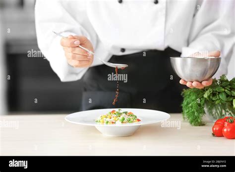 Female Chef Adding Sauce To Garnish On Plate Closeup Stock Photo Alamy