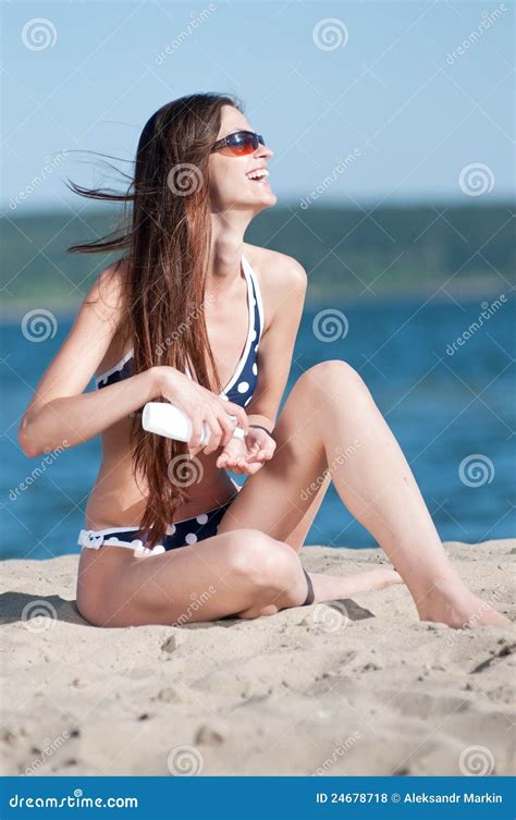 Beautiful Woman Applying Suntan Lotion At Beach Stock Photo Image Of