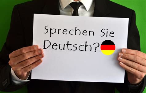 Businessman Showing A Sheet With Text Sprechen Sie Deutsch Stock Image