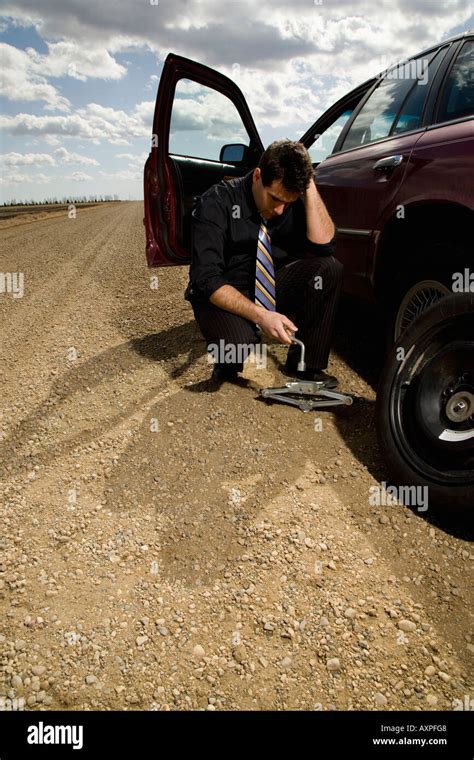 Man Changing Flat Tire Stock Photo Alamy