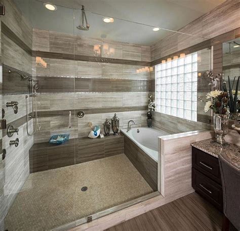 Beautiful bathtub decoration in bathroom interior. Giant shower and bath combination in neutral beiges with ...