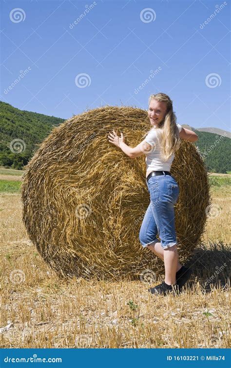 Blonde Girl Leaning Against A Rolling Haystack Stock Image Image Of