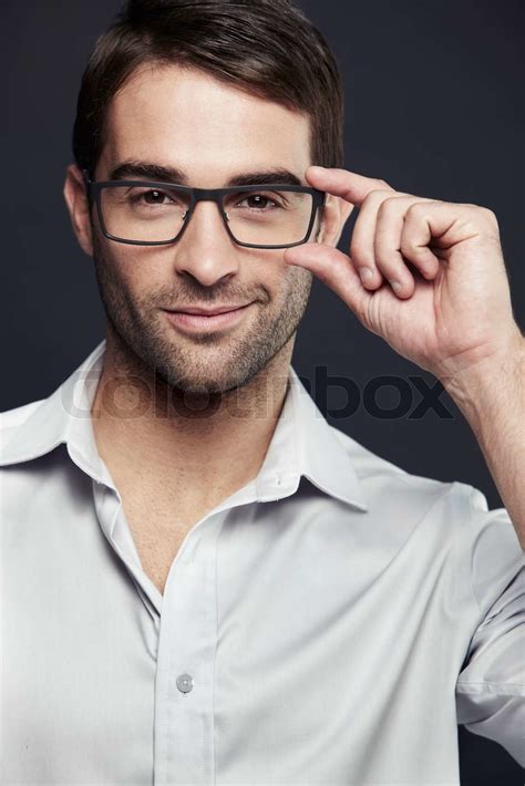 Mid Adult Man Adjusting Glasses Studio Shot Stock Image Colourbox