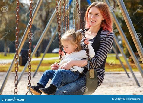 Mother And Daughter In A Swing At The Park Stock Image Image Of Modern Person 71804913