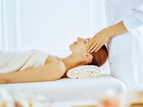 Beautiful Woman Enjoying Facial Massage With Closed Eyes In Spa Center Relax Treatment Concept