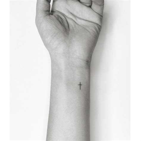 Minimalistic Cross Tattooed On The Wrist