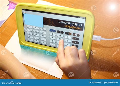 Child On A Laptop Computer Makes Calculations On The Background Of The