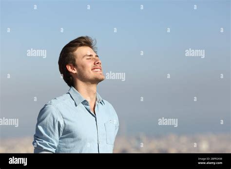 Happy Man Breathing Deeply Fresh Air In The City Outskirts Stock Photo