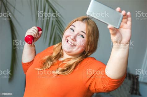 Chubby Woman Sport At Home Standing Taking Selfie Photos With Dumbbell