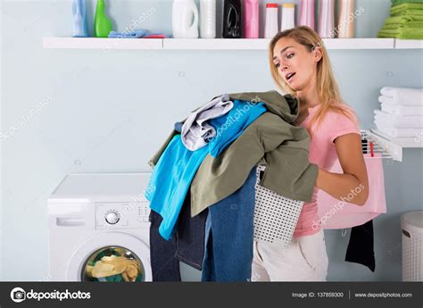 Woman Holding Bucket Of Clothes — Stock Photo © Andreypopov 137859300