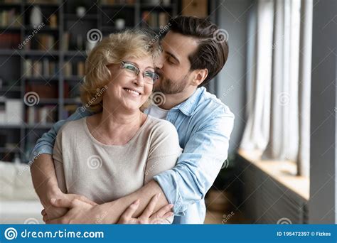 Loving Adult Son Kissing And Hugging Happy Mature Mother Royalty Free