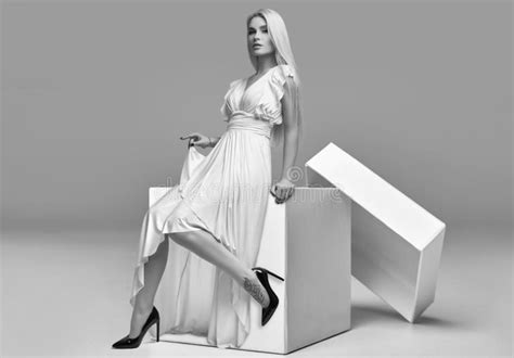 Gorgeous Sensual Blonde Woman In White Dress In A Big Shopping Box