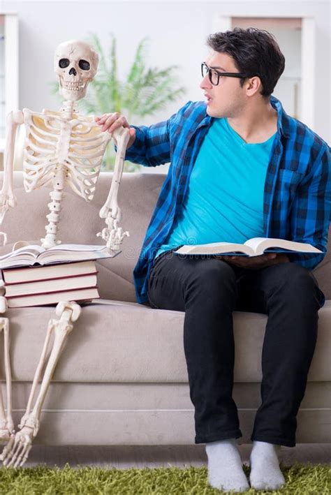 The Student Studying With Skeleton Preparing For Exams Stock Photo