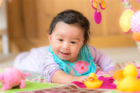Happy Smiling Baby Girl Playing With Toys Stock Photo Image Of Lying