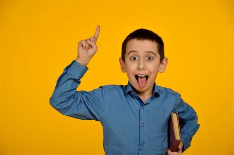 Premium Photo Little Boy In Blue Shirt Makes Funny Face
