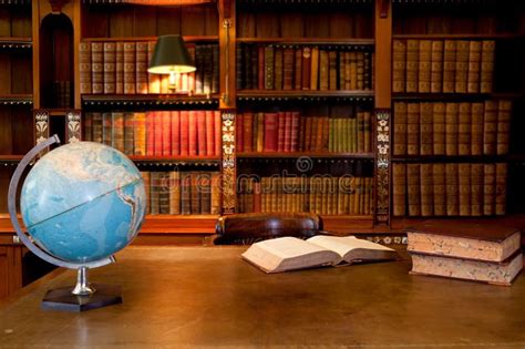 Old Library Interior An Open Book On A Desk Beside A Blue World Globe