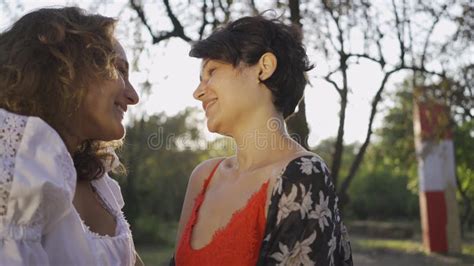 portrait of two attractive women laughing and rubbing noses close up beautiful lesbian couple